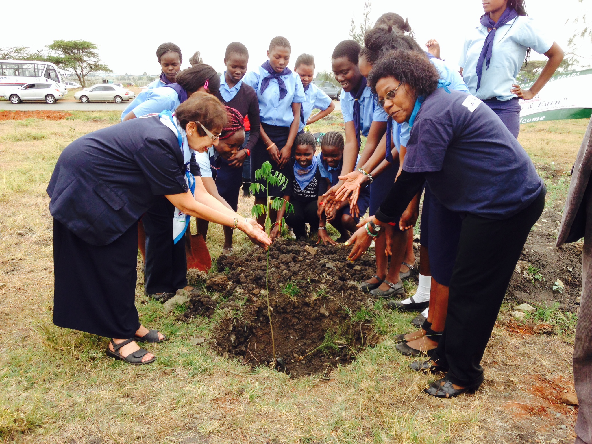 Shariffa and the girls planting a tree after their inaugraition into the Kenya Girl Guides Association