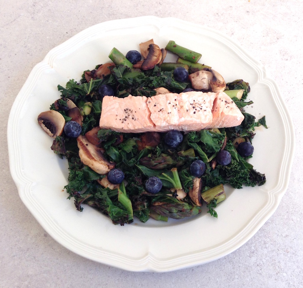 Warm Kale & Blueberry Salad topped with Poached Salmon