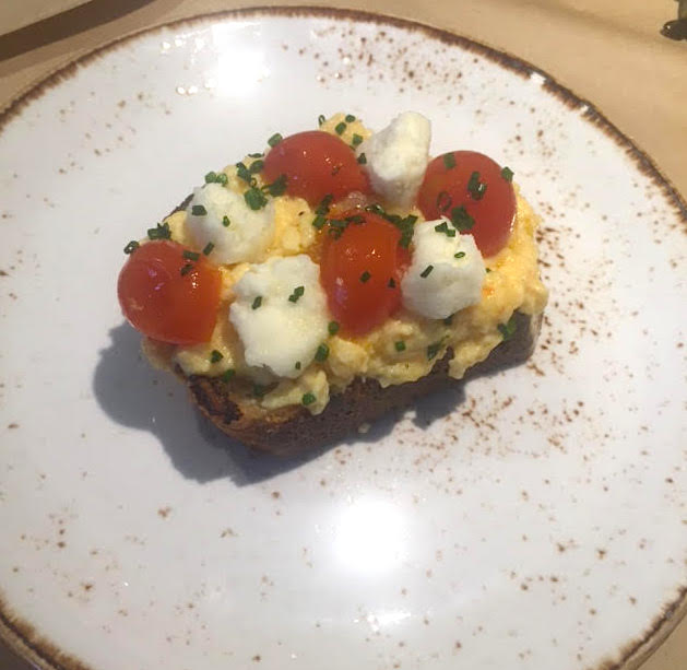 Greek scrambled eggs on grilled sourdough bead with wilted cherry tomatoes & barrel matured feta.